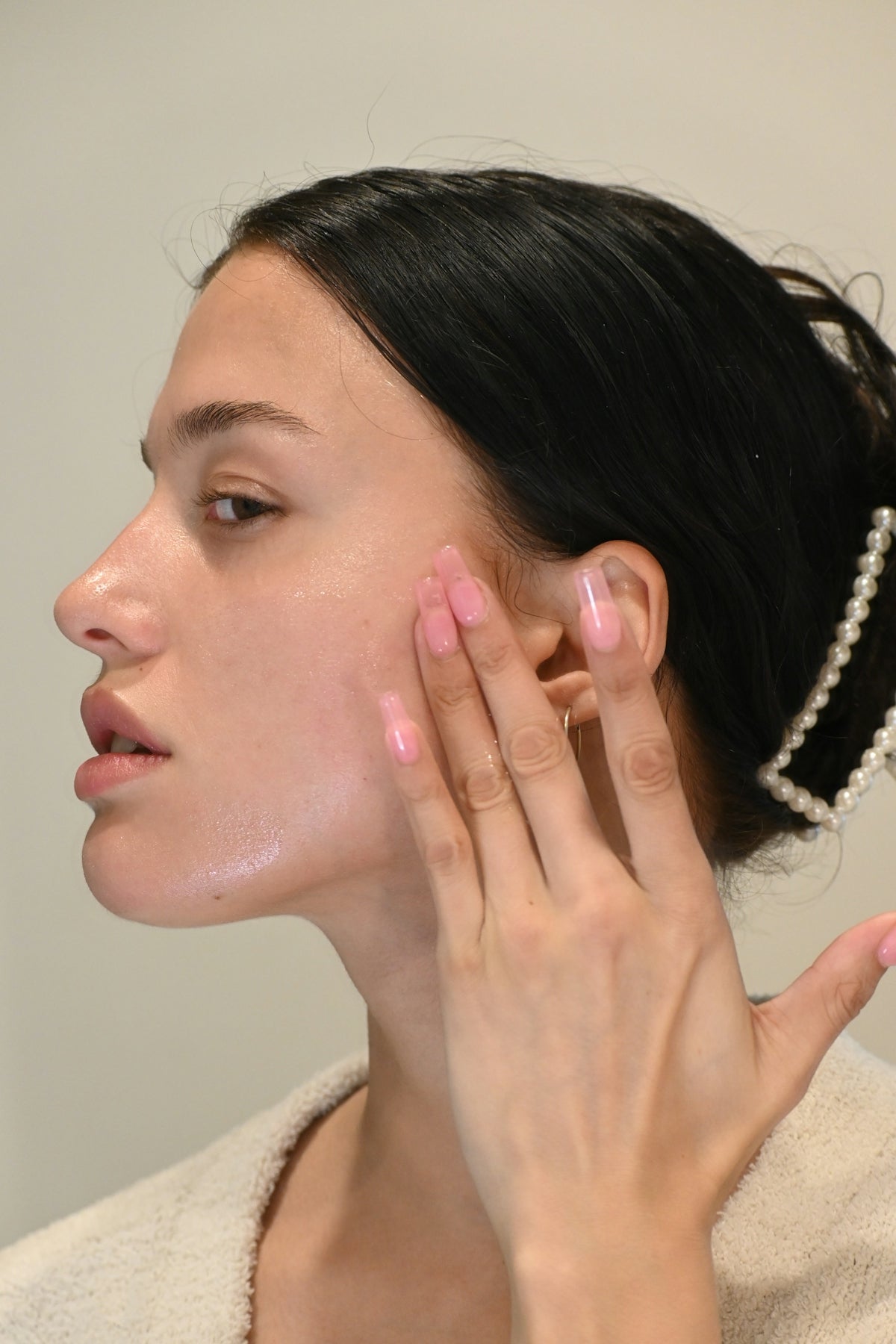 a woman with her hand on her face
