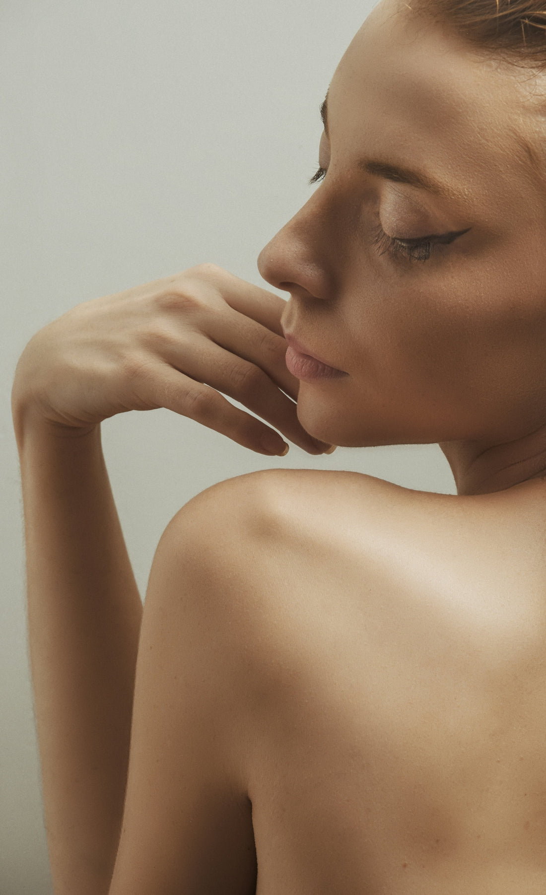a close up of a woman with her hand on her face